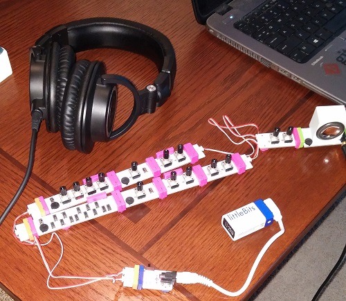 a set of littleBits electronic music components attached to a pair of headphones